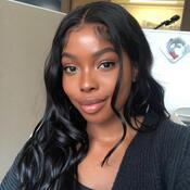 CRDSSA Junior Finance Christabel Oghinan. Christabel has long black hair that is worn down and curled. She is smiling in a selfie style photo. She is wearing a black sweater. 