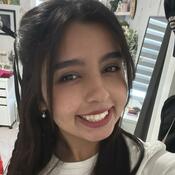 Junior Events and Communications Sehaab Babar. Sehaab has dark brown, nearly black hair that is worn down. She is smiling in a selfie style photo. She is wearing a white tee shirt. 