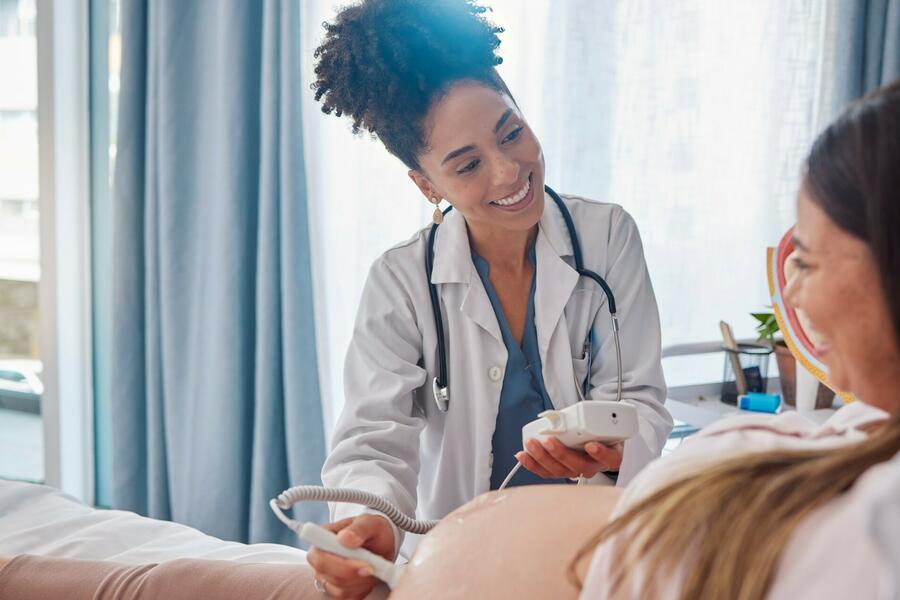 Female doctor performing an ultrasound on her pregnant patient
