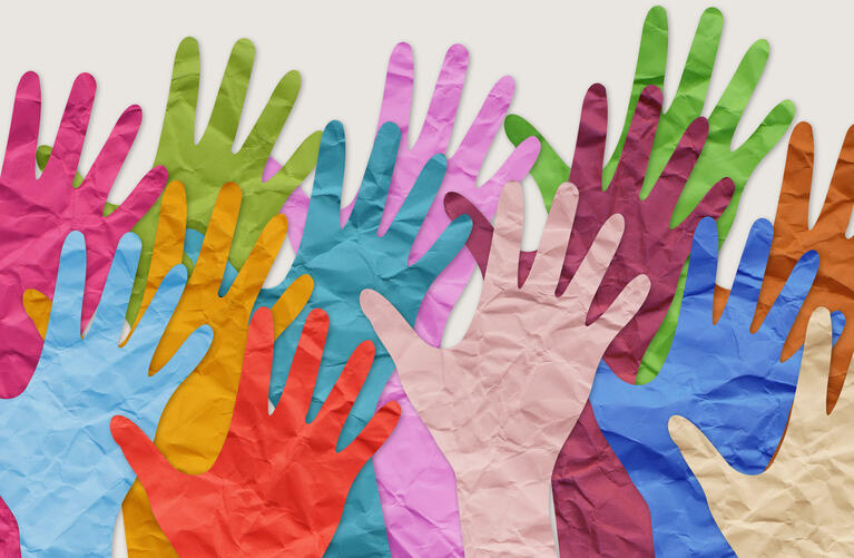 a photo of paper hands. They are all different colors (blue, pink, green, purples etc.)
