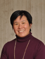 Headshot of Dr. Pamela Chu, wearing a plum-coloured sweater ag