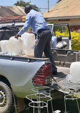 men delivering hand washing stations