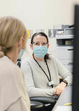 healthcare provider talking to adult patient