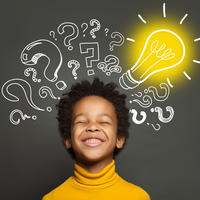 Boy thinking with lightbulbs and questions marks around his head