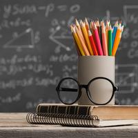 Teachers' desk: pencils, book, glasses