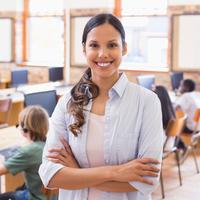 Teacher in classroom with desktop computers