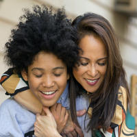 Mom hugging teenage child