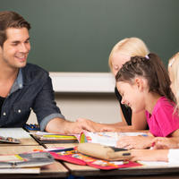 Teacher and children around a table