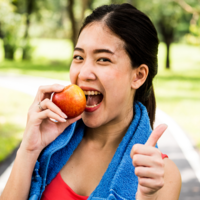 Young woman, exercising and eating an apple