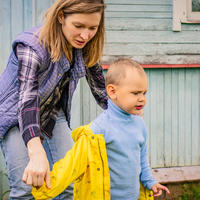 Mum helping son with jacket