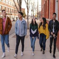 Teenagers walking along street