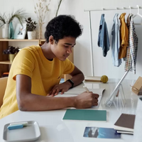 Youth writing on paper