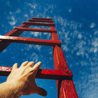 Hand on a red ladder leading to a blue sky