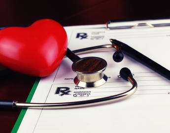 stethoscope and image of a heat on top of clip board