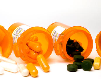 Different pills and pill bottles spilled out
