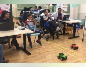 Two boys racing remote control cars with BCI