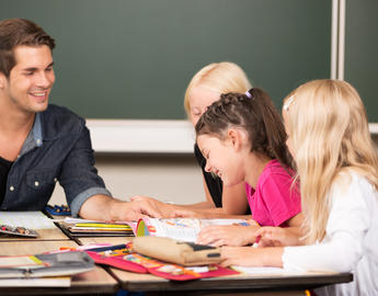 Teacher and children sitting around table