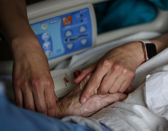 Holding patient hand
