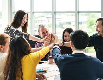 Group of people giving each other high fives