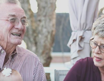 An elderly man and woman laughing