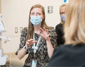 Three female physicians having a conversation in the lab.