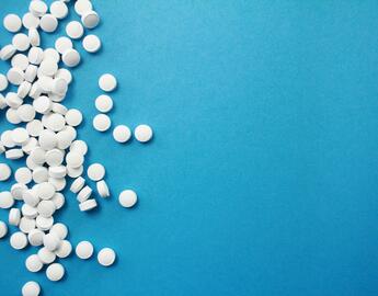 White pills on a blue background