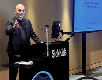 Christos presenting at lectern